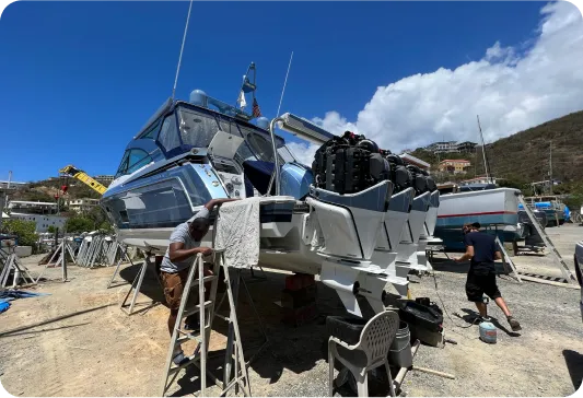 An image of a boat on stands being worked on