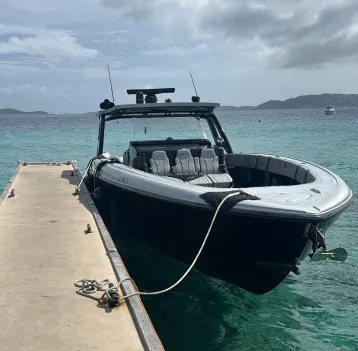 A black boat that is docked